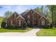 Charming brick home with manicured lawn and mature landscaping on a sunny day at 2840 Wheatfield Ct, Lincolnton, NC 28092