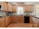 Traditional kitchen featuring wood cabinets, granite countertops, and a window view at 2840 Wheatfield Ct, Lincolnton, NC 28092