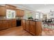 Kitchen with hardwood floors, central island, dark countertops, and open access to the living area at 2840 Wheatfield Ct, Lincolnton, NC 28092