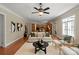 Inviting living room featuring hardwood flooring, ceiling fan, fireplace, and comfortable seating arrangement at 2840 Wheatfield Ct, Lincolnton, NC 28092