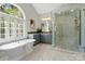 Luxury bathroom with soaking tub, glass shower and marble floors at 2840 Wheatfield Ct, Lincolnton, NC 28092