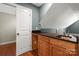 A wet bar area with wood cabinets, countertop and a sink next to a door at 2840 Wheatfield Ct, Lincolnton, NC 28092
