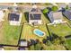 Aerial view shows the home with pool, solar panels, fenced yard, and shed at 3010 Berry Creek Rd, Charlotte, NC 28214