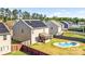 A sunny backyard features a kidney-shaped pool, a small screened porch, solar panels, and fenced yard for outdoor enjoyment at 3010 Berry Creek Rd, Charlotte, NC 28214