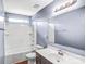 Bright bathroom featuring a tub, white vanity, and large mirror, perfect for relaxation and getting ready at 3010 Berry Creek Rd, Charlotte, NC 28214