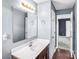 Neat bathroom with a clean vanity, well-lit mirror, and a view into the hall, offering convenience and style at 3010 Berry Creek Rd, Charlotte, NC 28214