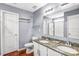 Well-lit bathroom with double sinks, granite countertops, and a glass door shower, offering a blend of style and functionality at 3010 Berry Creek Rd, Charlotte, NC 28214