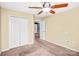 Spacious bedroom featuring double closets, a ceiling fan, and plush carpet, perfect for a comfortable retreat at 3010 Berry Creek Rd, Charlotte, NC 28214
