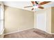 Inviting bedroom with a ceiling fan and neutral carpet, providing a cozy and comfortable living space at 3010 Berry Creek Rd, Charlotte, NC 28214