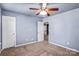The bedroom features neutral walls, plush carpeting, and access to an open doorway at 3010 Berry Creek Rd, Charlotte, NC 28214