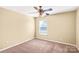 Cozy bedroom with neutral carpet, window, ceiling fan and ample natural light, offering a peaceful retreat at 3010 Berry Creek Rd, Charlotte, NC 28214