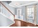 Welcoming foyer features hardwood floors, a staircase with white risers, and a decorative glass front door at 3010 Berry Creek Rd, Charlotte, NC 28214