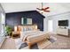 Comfortable main bedroom featuring soft carpet, a ceiling fan, and ample natural lighting at 3010 Berry Creek Rd, Charlotte, NC 28214
