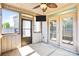 The screened porch has a ceiling fan and access to the backyard and double doors at 3010 Berry Creek Rd, Charlotte, NC 28214