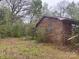 Exterior side and backyard view of a single story brick home with an attached garage at 307 Brook St, Salisbury, NC 28146