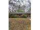 Single story brick home with covered front entrance and attached garage sits on a large wooded lot at 307 Brook St, Salisbury, NC 28146