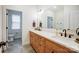 Modern bathroom features double sinks with a wooden vanity and a view into a toilet room with hexagon tile at 317 Boyd Rd, Clover, SC 29710