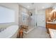 Spacious bathroom with a walk-in shower, soaking tub, and bright tile flooring at 317 Boyd Rd, Clover, SC 29710