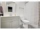 Bathroom featuring a gray vanity, toilet, framed mirror, and a striped shower curtain at 317 Boyd Rd, Clover, SC 29710