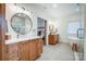 Bathroom featuring double sinks, a soaking tub, a glass shower, and bright lighting fixtures at 317 Boyd Rd, Clover, SC 29710