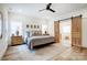 Well-lit bedroom featuring a large bed, wooden sliding doors, and serene ambiance for ultimate relaxation at 317 Boyd Rd, Clover, SC 29710