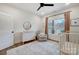 Bright Bedroom featuring a white crib, dresser with changing pad, neutral walls, and a window overlooking trees at 317 Boyd Rd, Clover, SC 29710