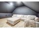 Cozy bonus room features a plush sectional sofa, hardwood floors, and dark gray painted walls at 317 Boyd Rd, Clover, SC 29710
