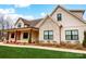 Detailed view of the new home with brick and siding exterior, covered porch and professional landscaping at 317 Boyd Rd, Clover, SC 29710