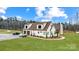 Beautiful home exterior featuring a three-car garage, well-manicured lawn, and complementary landscaping at 317 Boyd Rd, Clover, SC 29710
