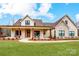 Charming exterior of a home with stone accents, wooden pillars, and rocking chairs on the covered porch at 317 Boyd Rd, Clover, SC 29710