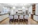 Stylish kitchen with a central island, barstools, white cabinets, stainless appliances, and hardwood floors at 317 Boyd Rd, Clover, SC 29710