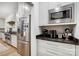 Stainless steel refrigerator and microwave complement the black countertops and white cabinetry at 317 Boyd Rd, Clover, SC 29710
