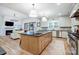 Modern open concept kitchen, island with seating and stainless appliances, open to the Gathering room at 317 Boyd Rd, Clover, SC 29710