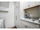 Close up of bright laundry room with white cabinets, sink and modern fixtures at 317 Boyd Rd, Clover, SC 29710