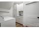 Bright laundry room with white cabinets, washer, dryer and modern fixtures at 317 Boyd Rd, Clover, SC 29710