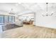 Bright, open-concept living room features modern lighting, a neutral palette, and hardwood floors at 317 Boyd Rd, Clover, SC 29710