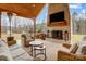 Outdoor living area with a wood-burning fireplace, wicker furniture, and a view of the backyard at 317 Boyd Rd, Clover, SC 29710