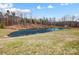 Scenic view of a tranquil pond reflecting the surrounding trees and sky, complemented by a grassy bank at 317 Boyd Rd, Clover, SC 29710