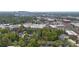 Stunning aerial view capturing a vibrant neighborhood with a mix of residential and commercial properties and lush trees at 3414 Chagall Ct, Charlotte, NC 28205