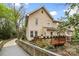 A lush backyard featuring a well-maintained deck adorned with potted plants, accessible via a charming bridge at 3414 Chagall Ct, Charlotte, NC 28205