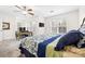 Spacious bedroom featuring a desk, TV, comfortable bed, ceiling fan, and ample natural light from the windows at 3414 Chagall Ct, Charlotte, NC 28205