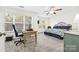 Spacious bedroom with ample natural light, a ceiling fan, a workspace, and a comfortable sleeping area at 3414 Chagall Ct, Charlotte, NC 28205