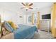 Comfortable bedroom featuring soft blue bedding, a ceiling fan, and a dresser, creating a peaceful retreat at 3414 Chagall Ct, Charlotte, NC 28205