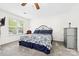 Bright bedroom with a comfortable bed, ceiling fan, large window, and light-colored walls for a serene ambiance at 3414 Chagall Ct, Charlotte, NC 28205