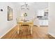 Cozy dining area with modern lighting, wood floors, and a view into the adjacent kitchen with granite countertops at 3414 Chagall Ct, Charlotte, NC 28205
