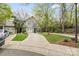 Townhouse with well-manicured landscaping, blue roof, long driveways and mature trees at 3414 Chagall Ct, Charlotte, NC 28205