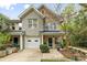 Attractive townhome with stone accents, a front porch, and meticulously maintained landscaping at 3414 Chagall Ct, Charlotte, NC 28205