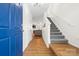 Bright foyer with wood-look flooring, staircase, coat closet, and views into the living area at 3414 Chagall Ct, Charlotte, NC 28205