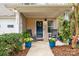 Inviting front porch with rocking chairs, potted plants, and a charming wreath on the blue front door at 3414 Chagall Ct, Charlotte, NC 28205