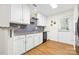 Functional kitchen featuring white cabinetry, stainless steel sink, modern hardware, and a stylish tile backsplash at 3414 Chagall Ct, Charlotte, NC 28205